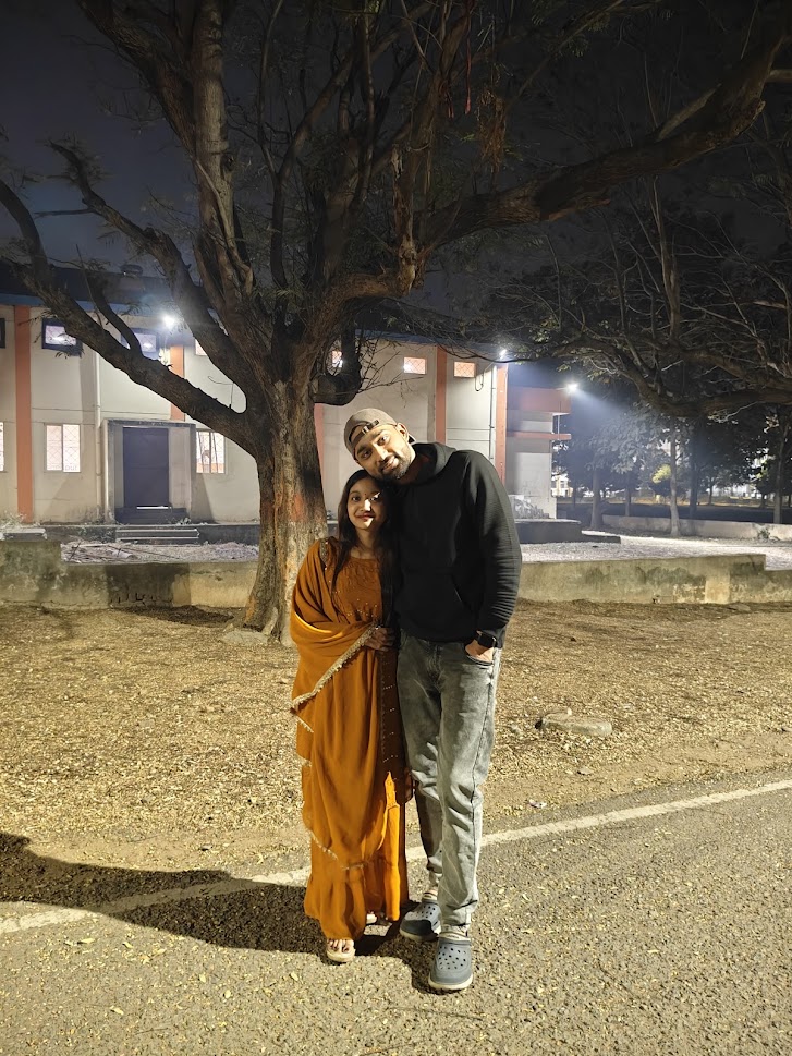 Standing together under a tree at night